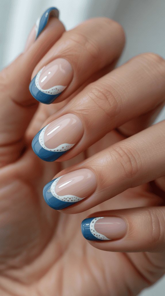 Elegant beach-inspired nail art featuring blue tips and white wave details for a seaside look.