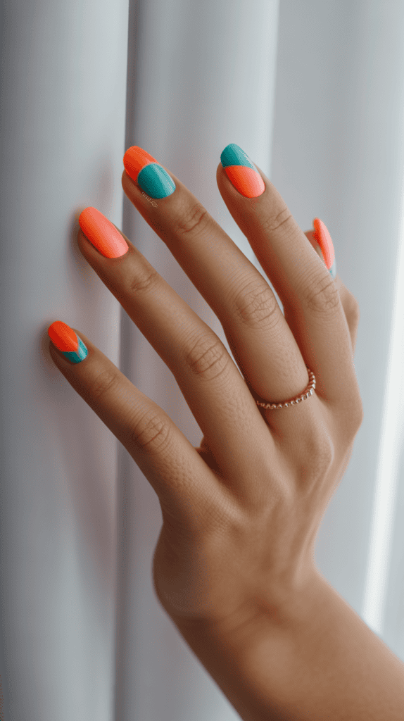 Colorful tropical nail design with coral, teal, and orange shades for summer vacations.