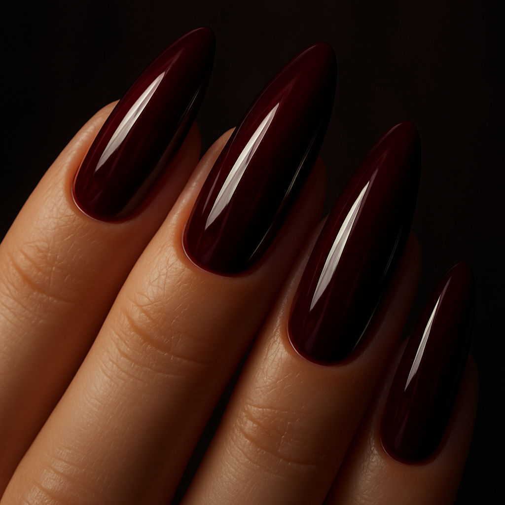 Close-up of hands with wine red nails in a stylish almond shape